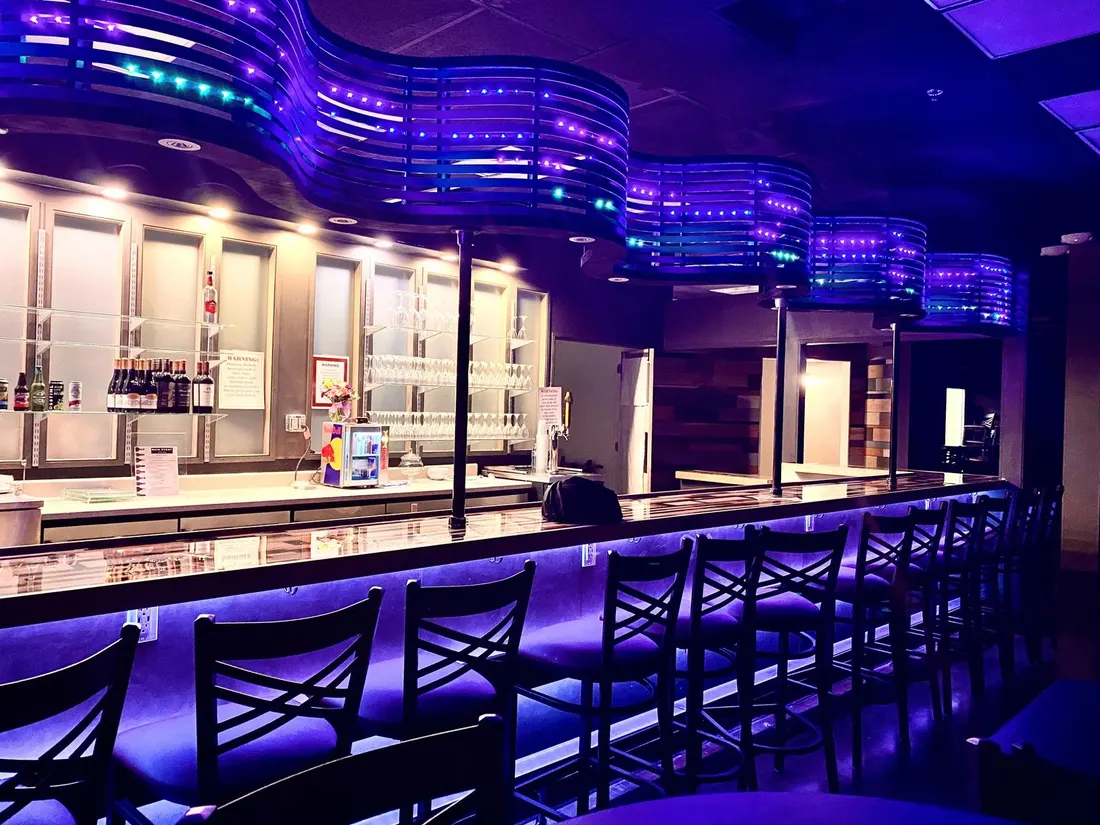 The Club Room's blue-lit cocktail bar at Main Event