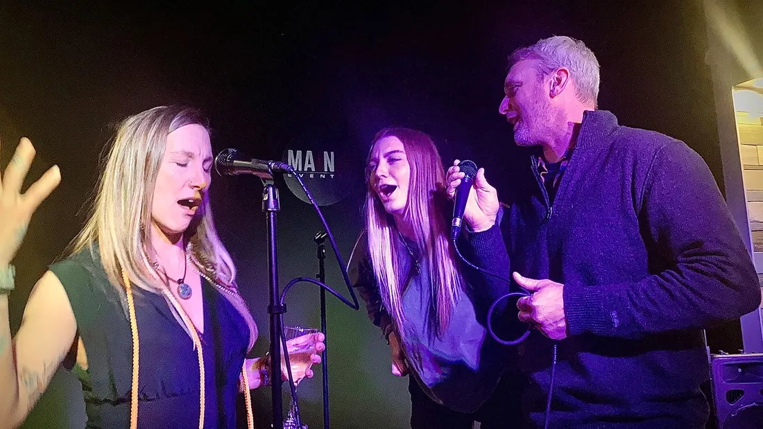 Guests singing and celebrating at a Main Event party